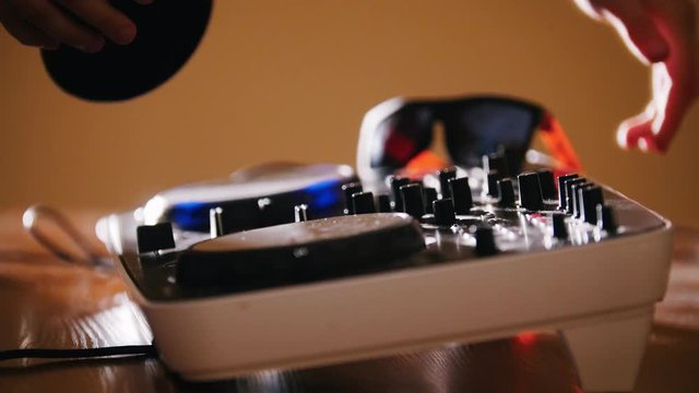 DJ TAKES HEADPHONES FROM AUDIO CONSOL AND TURN IT ON