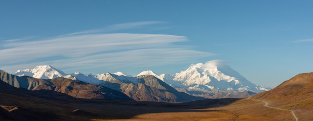 Long golden valley in front of snowy Denali in Autumn © latitude59