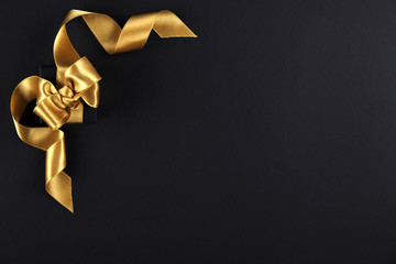 Beautiful minimalistic multi purpose composition with gift box wrapped and tied with satin ribbon. Holiday present in festive wrapping. Background, copy space, close up, top view, flat lay.