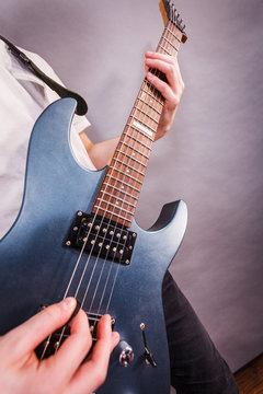 Close up of man playing on electric guitar