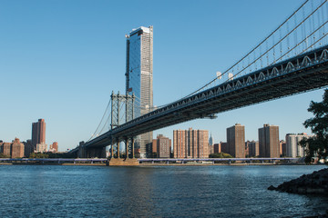 Fototapeta na wymiar Manhattan Bridge over East River at the early morning sun light. The Bridge connects Lower Manhattan with Brooklyn of New York, USA.