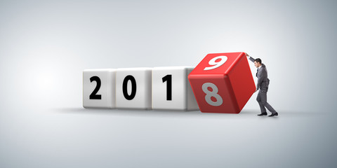 Businessman employee rotating cube to reveal number 2019