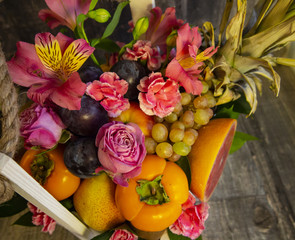 composition of fruit and flowers in a decorative box