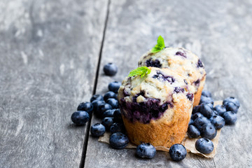 Delicious  blueberry muffins on wooden table