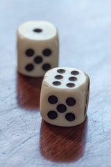 White dice on wooden background. Concept of luck, chance and leisure fun, numbers 1 and 6