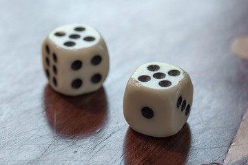 White dice on wooden background. Concept of luck, chance and leisure fun, number 5