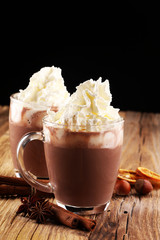 Hot chocolate cocoa with whipped cream on table.