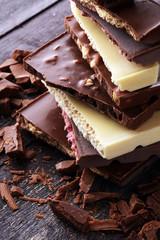 Chocolate bars on table with chocolate tower.