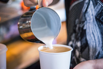 Making cappuccino and latte in a caffee shop