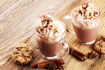 Hot chocolate cocoa with whipped cream on table.