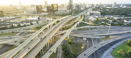 Panorama aerial Interstate I-610 freeway massive intersection and Houston midtown skylines...