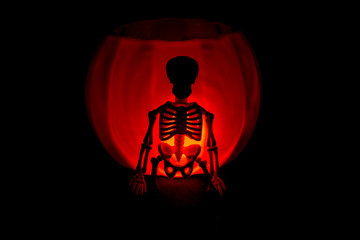 bright halloween pumpkin and skeletons silhouette