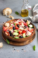 Fototapeta na wymiar Panzanella, traditional Italian bread, tomato and basil salad. Summer healthy food. Copy space.