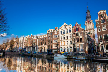 Canals, boats and beautiful architecture at the Old Central district in Amsterdam - obrazy, fototapety, plakaty