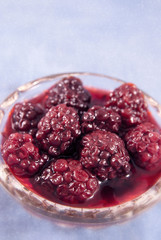 Blackberry in a glass bowl on the linen cloth