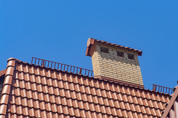 Details of the red tile roof on sky background.