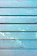 Background from smooth boards painted with light blue paint. Texture with stains of paint.