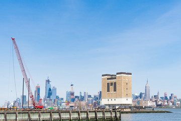 Fototapeta na wymiar Floating construction crane on Hudson River, Jersey City in the background