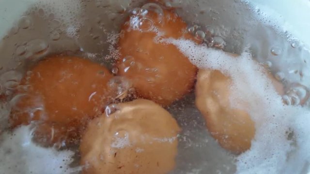 Eggs are boiled in a pot in kitchen at home