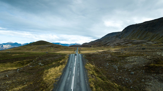 Drone photography of road in iceland leading the way through the landscape