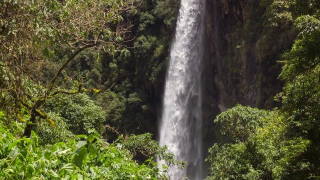Condor Machay Waterfall in a lush cloudforest valley near Cotopaxi Volcano, Ecuador. Time-lapse.