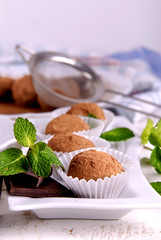 Homemade truffle sweets and fresh mint on the kitchen table.