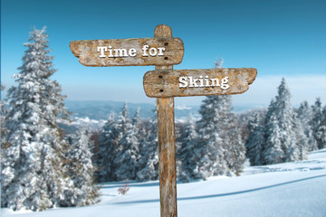 Time for skiing. Information sign and blurred background.