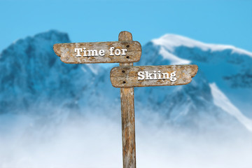 Time for skiing. Information sign and blurred background.