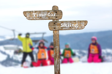 Time for skiing. Information sign and blurred background.