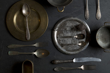 Vintage kitchen utensils on a dark stone background