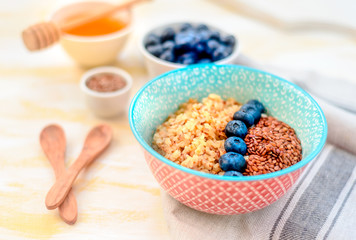 Buckwheat porridge in a bowl with flax seeds and blueberries. oncept healthy food, detox, diet, breakfast