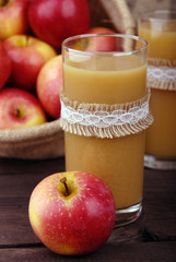 Fresh juice from red apples in a glass beaker.