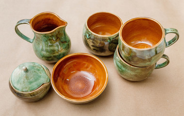 still life of the clay pottery teapot and cup and dishes