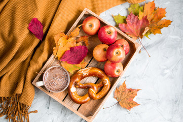 Tea Cup with Coffee Autumn Time Bakery Pretzel Toned Photo Knitting Scarf Blanket Yellow Leaves Gray Background