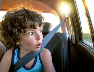 Cheerful boy inside the car enjoy traveling on vacation and shocked of accident concept