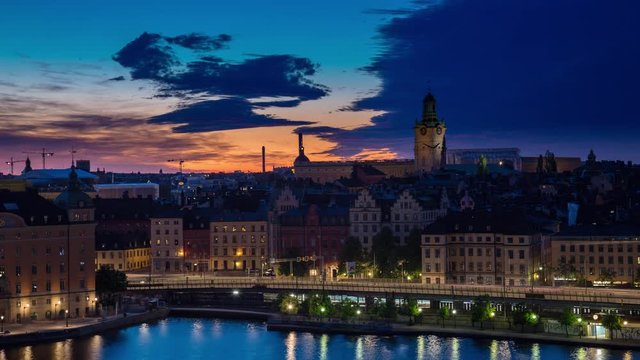Sunset Night time lapse in Stockholm showing water and traffic passing on a bridge, Sweden