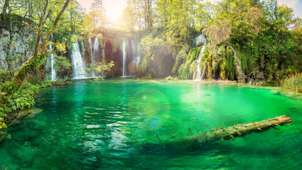panoramic view of beautifully lit waterfall and lake