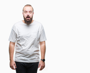 Fototapeta premium Young caucasian hipster man wearing casual t-shirt over isolated background afraid and shocked with surprise expression, fear and excited face.
