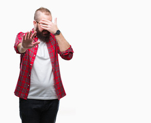 Young caucasian hipster man wearing glasses over isolated background covering eyes with hands and doing stop gesture with sad and fear expression. Embarrassed and negative concept.
