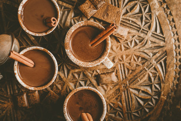 Fototapeta na wymiar Tasty hot chocolate drink in small cups
