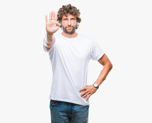 Handsome hispanic model man over isolated background doing stop sing with palm of the hand. Warning...