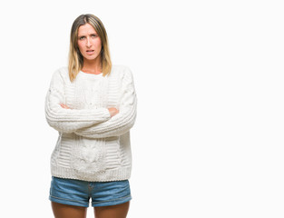 Fototapeta premium Young beautiful woman wearing winter sweater over isolated background skeptic and nervous, disapproving expression on face with crossed arms. Negative person.