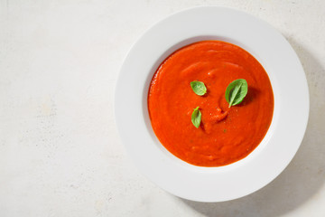 Creamy tomato soup served in bowl