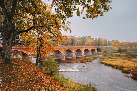 Autumn landscape. The Old Brick Bridge across the Venta river in Kuldiga, Latvia.