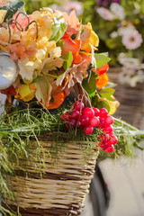 autumn bouquet with grape and fogliage, basket on bike closeup