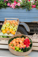 fruits in a box for sale on the street near a truck, Italy, Apulia, Salento, vertical