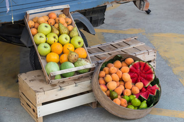 fruits in a box for sale on the street near a truck, Italy, Apulia, Salento, horizontal