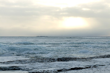 Baltic sea on wintertime with broken ice cracks large pieces of floating ice