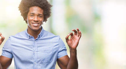 Afro american man over isolated background relax and smiling with eyes closed doing meditation gesture with fingers. Yoga concept.