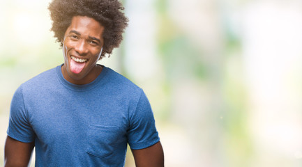 Afro american man over isolated background sticking tongue out happy with funny expression. Emotion concept.